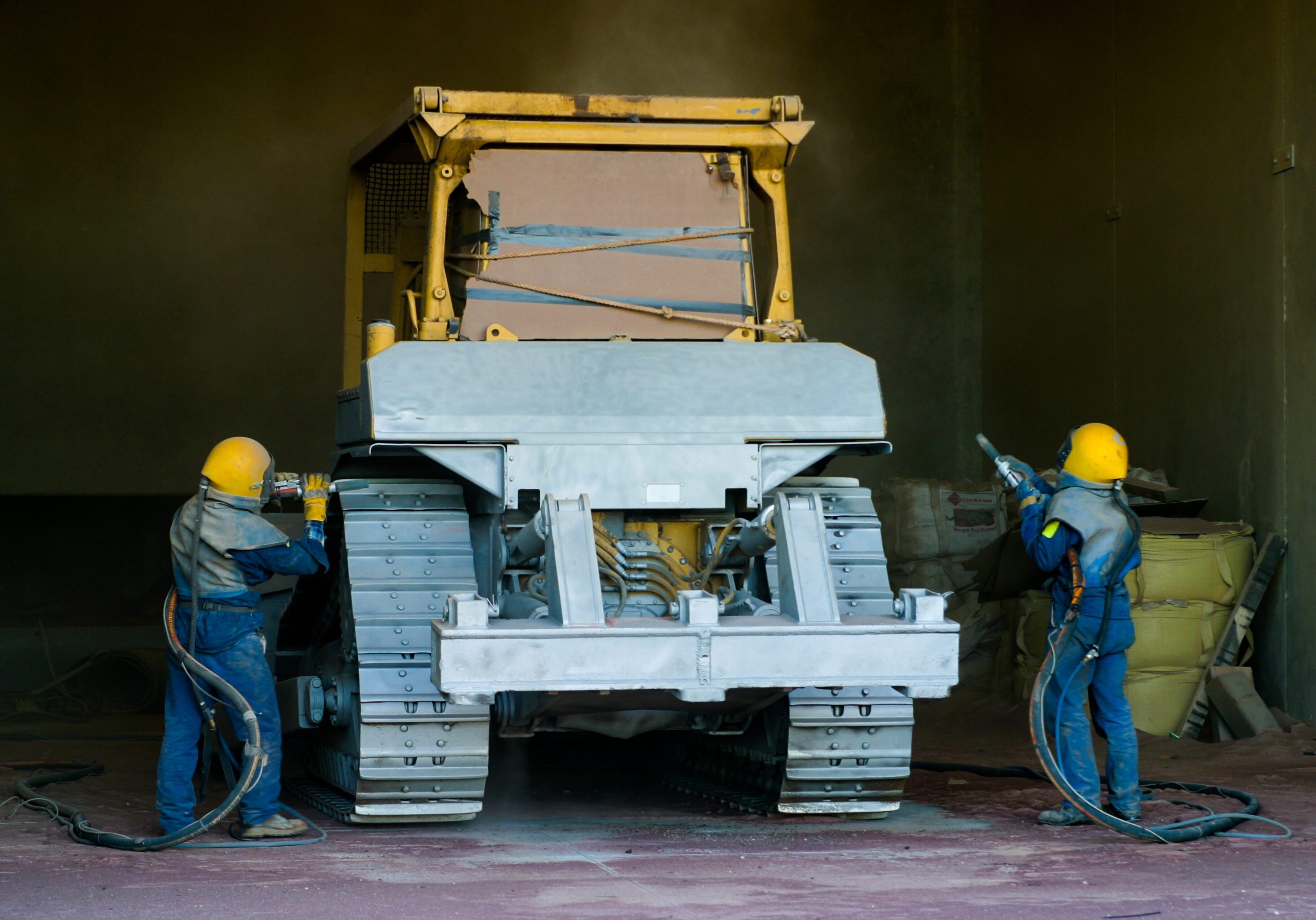 Sandblasting process on heavy machinery